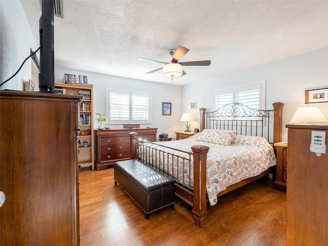 bedroom with ceiling fan and light hardwood / wood-style flooring