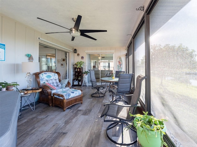 sunroom featuring ceiling fan