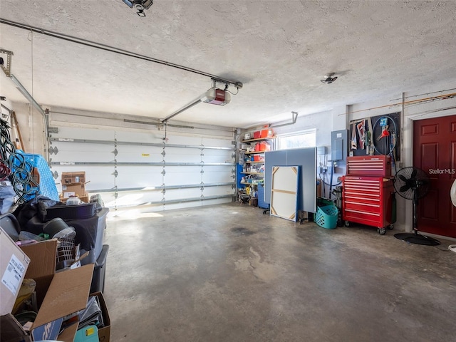 garage with a garage door opener and electric panel