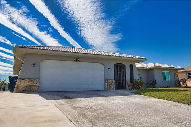 view of front facade with a garage and a front lawn