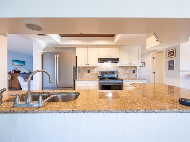 kitchen featuring appliances with stainless steel finishes, tasteful backsplash, sink, white cabinets, and light stone countertops