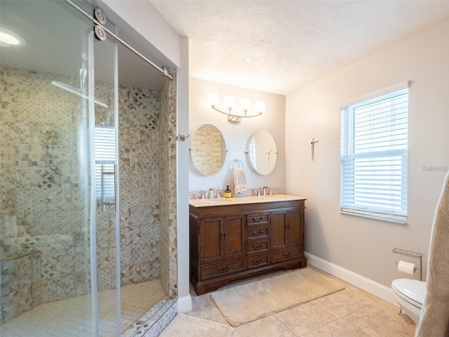 bathroom with vanity, toilet, tile patterned floors, and walk in shower