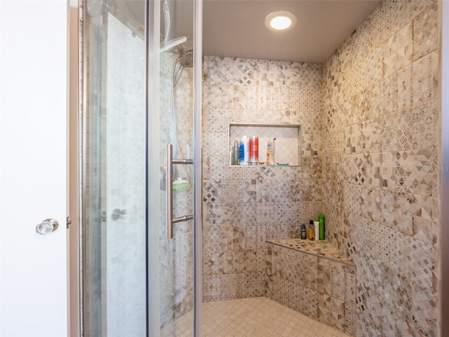 bathroom with a shower with door