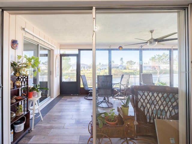 sunroom / solarium featuring ceiling fan