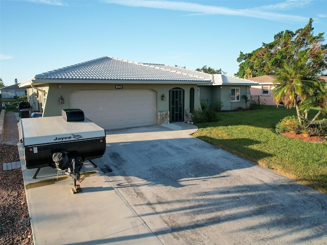 view of front of home featuring a garage and a front lawn