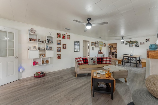 living room with ceiling fan and hardwood / wood-style flooring