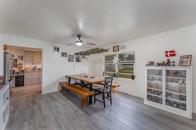 dining space featuring ceiling fan and wood-type flooring