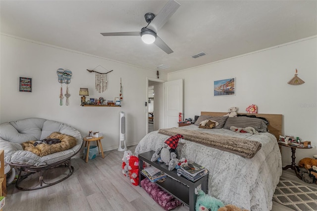 bedroom with ceiling fan and light hardwood / wood-style flooring