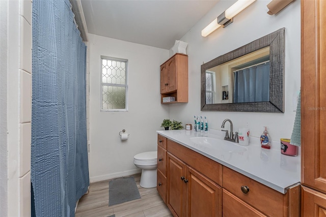 bathroom featuring toilet, vanity, a shower with shower curtain, and hardwood / wood-style floors