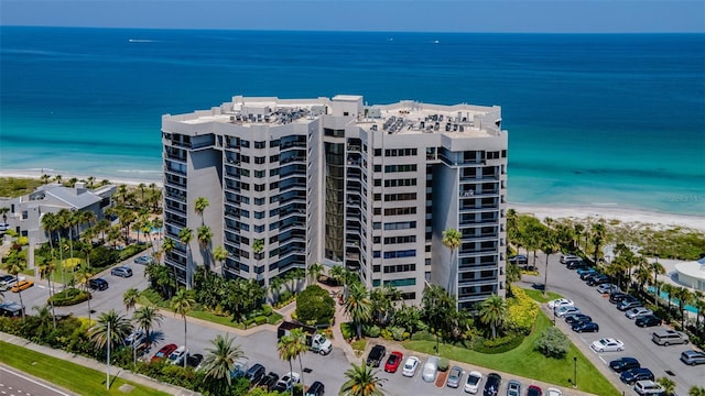 birds eye view of property featuring a beach view and a water view