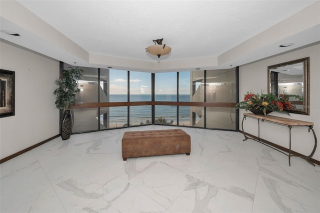 interior space with a water view and floor to ceiling windows