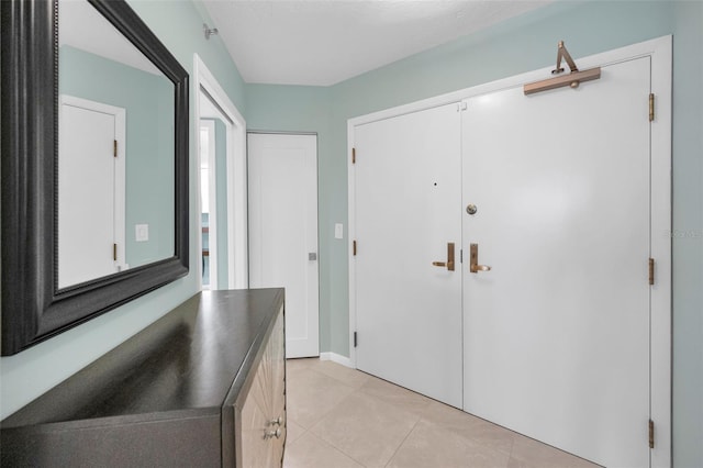 foyer entrance featuring light tile patterned floors