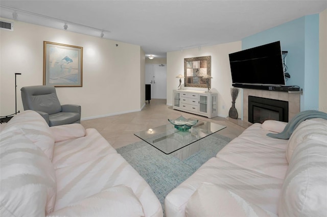 tiled living room featuring track lighting