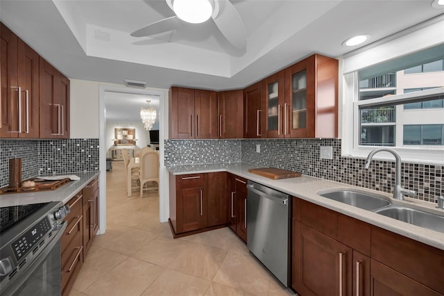 kitchen featuring decorative backsplash, sink, appliances with stainless steel finishes, and light tile patterned floors