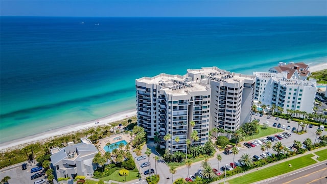 birds eye view of property featuring a water view and a view of the beach