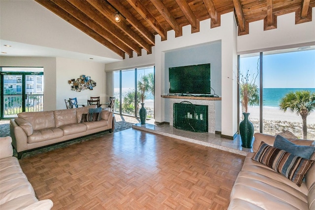 living room featuring a fireplace, parquet flooring, beamed ceiling, wood ceiling, and high vaulted ceiling