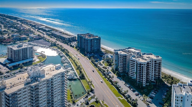 drone / aerial view featuring a beach view and a water view