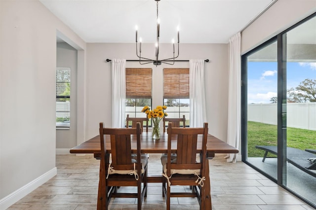 dining space with a chandelier and light hardwood / wood-style floors