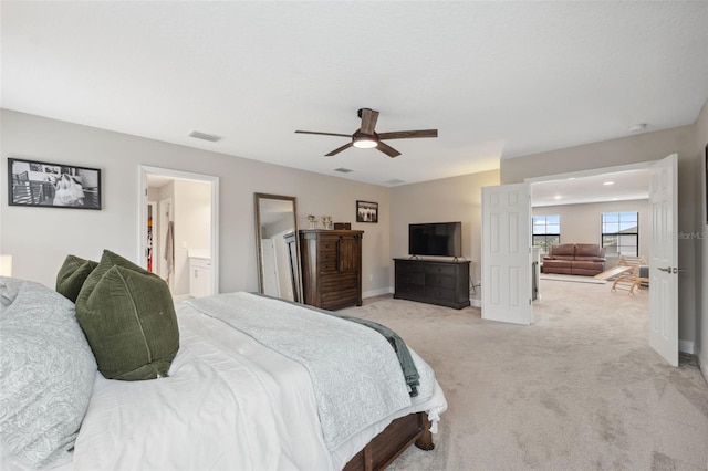 bedroom with ceiling fan and light carpet