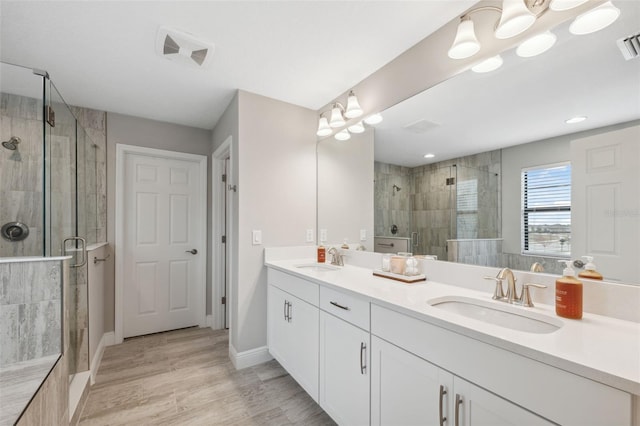 bathroom featuring vanity, hardwood / wood-style floors, and an enclosed shower