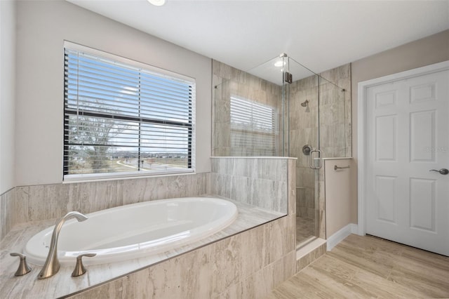 bathroom featuring hardwood / wood-style floors and separate shower and tub