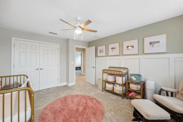 interior space with light carpet and ceiling fan