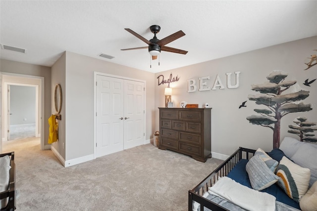 bedroom featuring light carpet, a closet, and ceiling fan