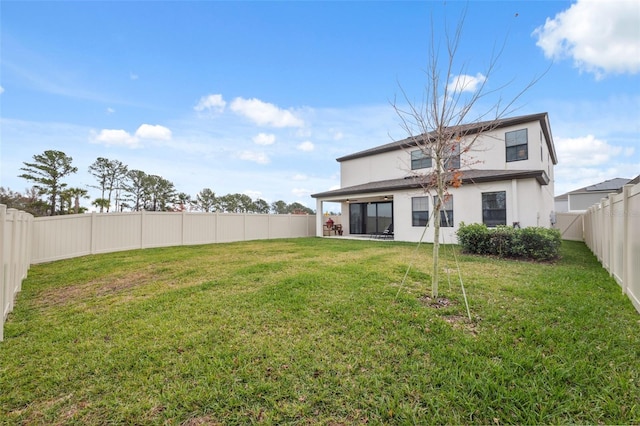 rear view of property with a lawn