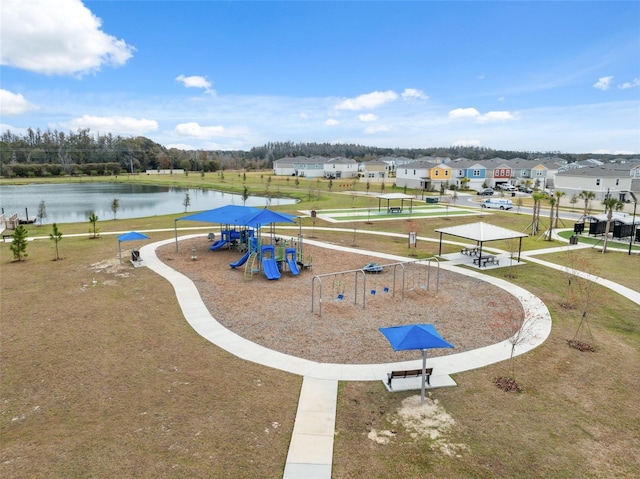 exterior space featuring a playground and a water view