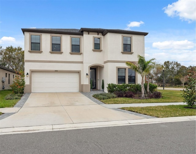 view of front of property with a garage and a front lawn