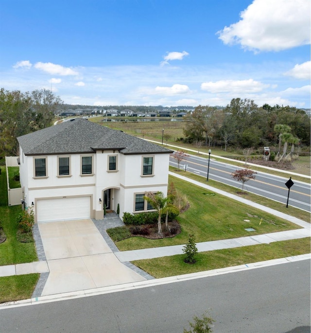 view of front facade with a garage and a front yard