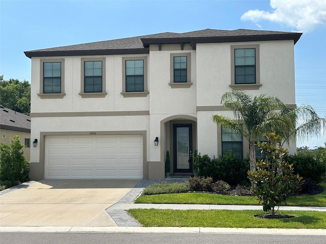 14786 Horse Trot Rd, Lithia, FL 33547 - view of front of property featuring concrete driveway, a garage, stucco siding, and roof with shingles