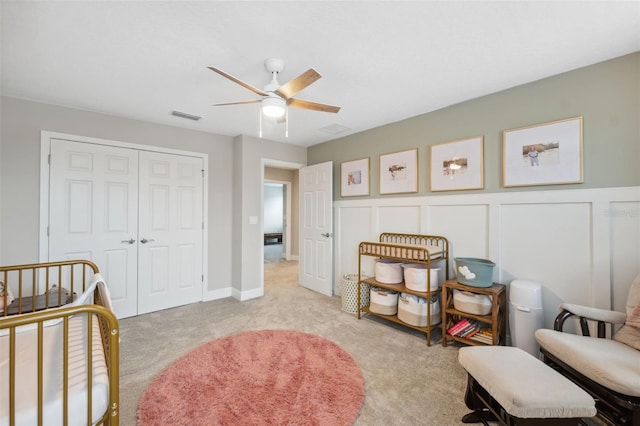 14786 Horse Trot Rd, Lithia, FL 33547 - bedroom featuring light colored carpet, a closet, a wainscoted wall, a ceiling fan, and a decorative wall