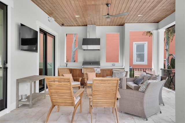 view of patio featuring exterior kitchen, grilling area, and ceiling fan