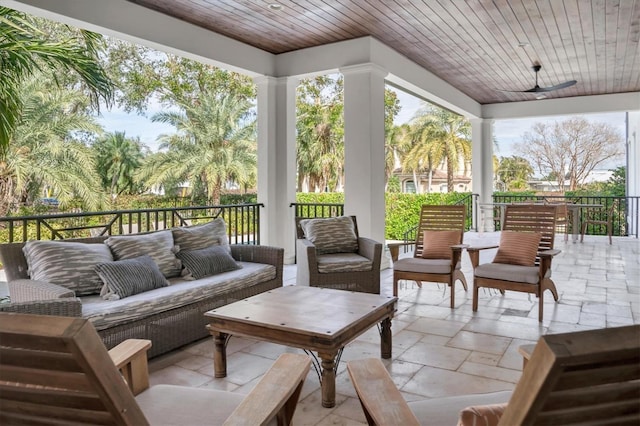 view of patio with an outdoor living space and ceiling fan