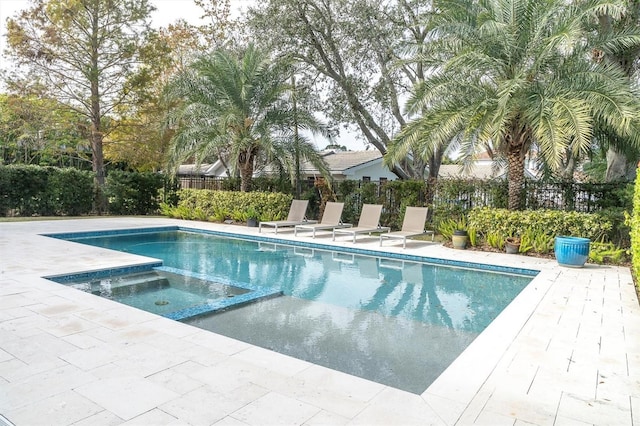 view of pool with an in ground hot tub and a patio