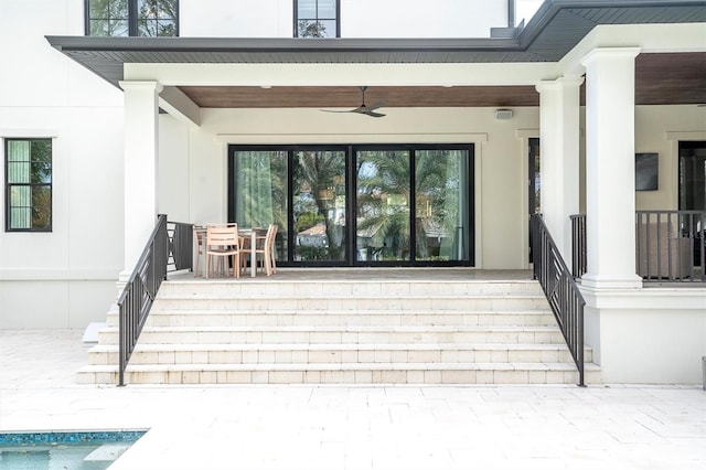 view of exterior entry with a patio area and ceiling fan