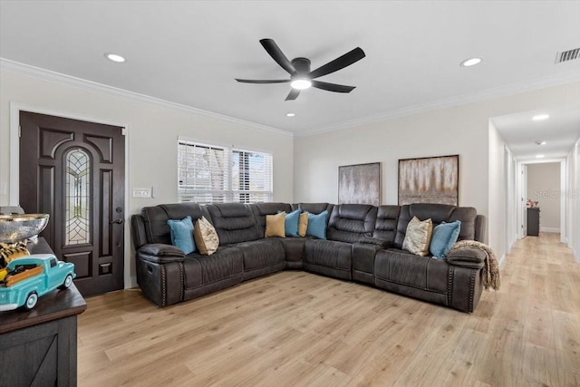 living room with crown molding, ceiling fan, and light wood-type flooring