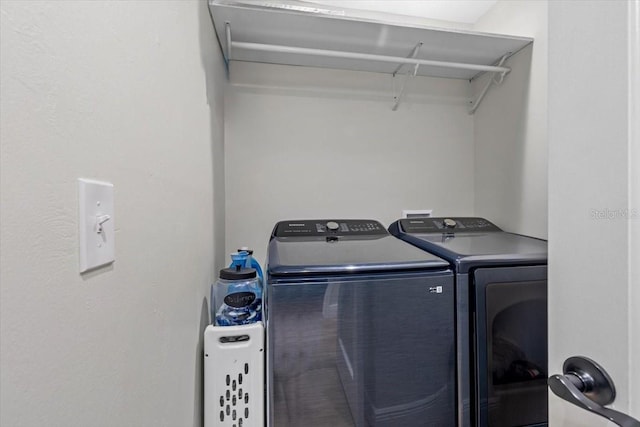 clothes washing area featuring washer and clothes dryer