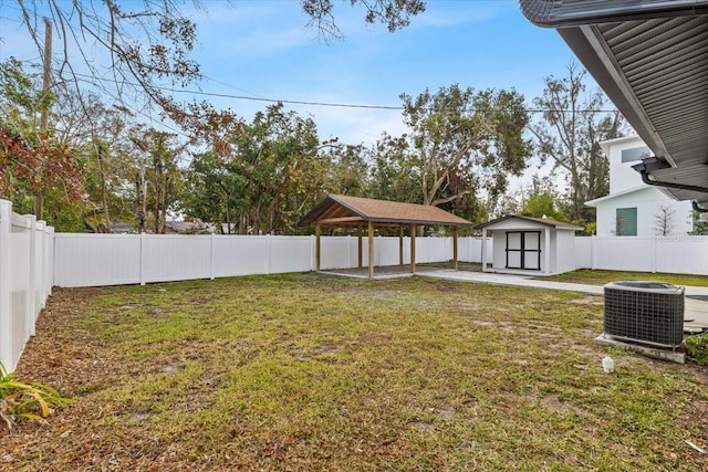 view of yard featuring a shed, a gazebo, a patio, and central air condition unit