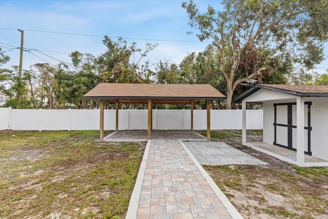 view of yard with a patio and a storage unit