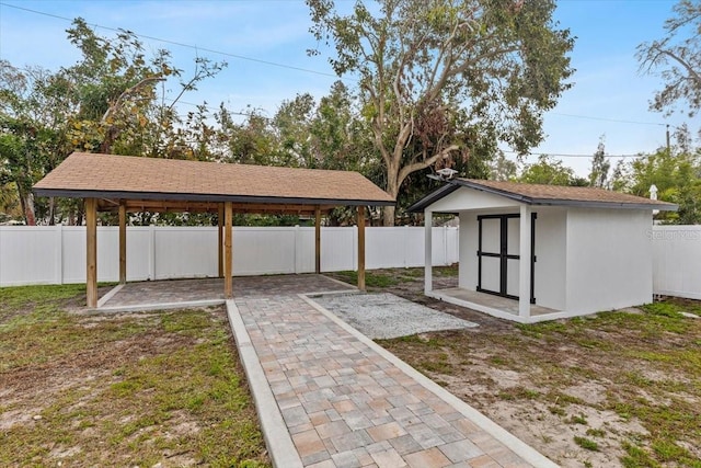 view of yard featuring a patio area and a storage unit