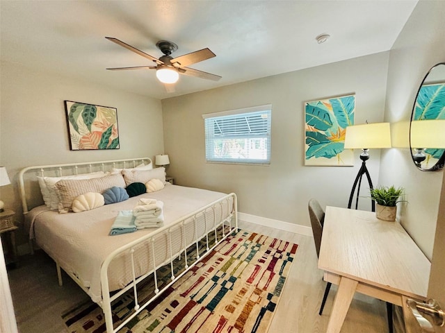 bedroom with ceiling fan and wood-type flooring