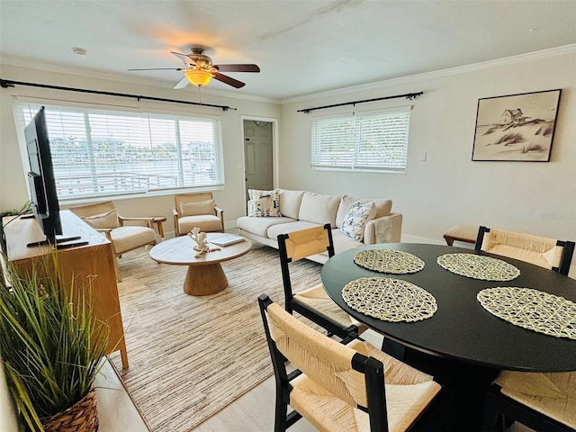 dining space featuring light hardwood / wood-style floors, crown molding, and ceiling fan