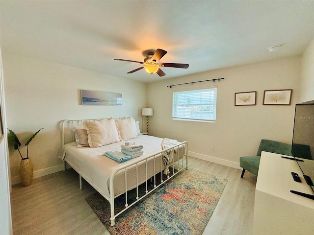 bedroom featuring light wood-type flooring and ceiling fan