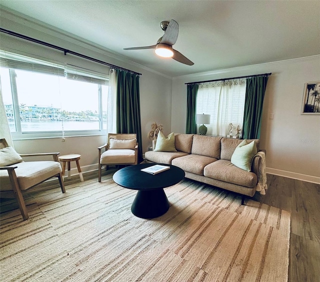 living room featuring ceiling fan, crown molding, and hardwood / wood-style flooring