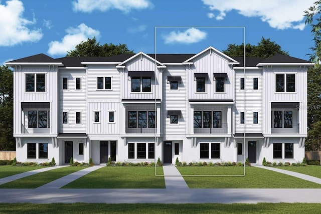 view of property with board and batten siding and a front lawn