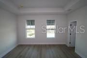 unfurnished room featuring dark hardwood / wood-style flooring and a healthy amount of sunlight