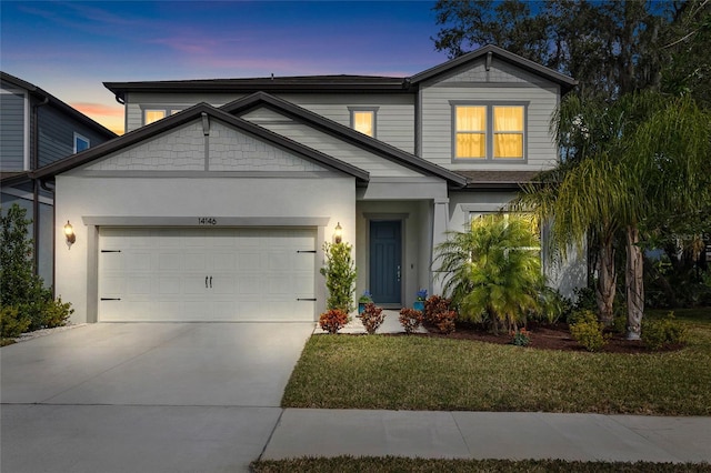 craftsman inspired home with a lawn and a garage