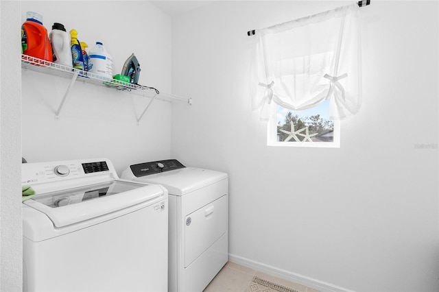 laundry room with light tile patterned floors and washer and dryer